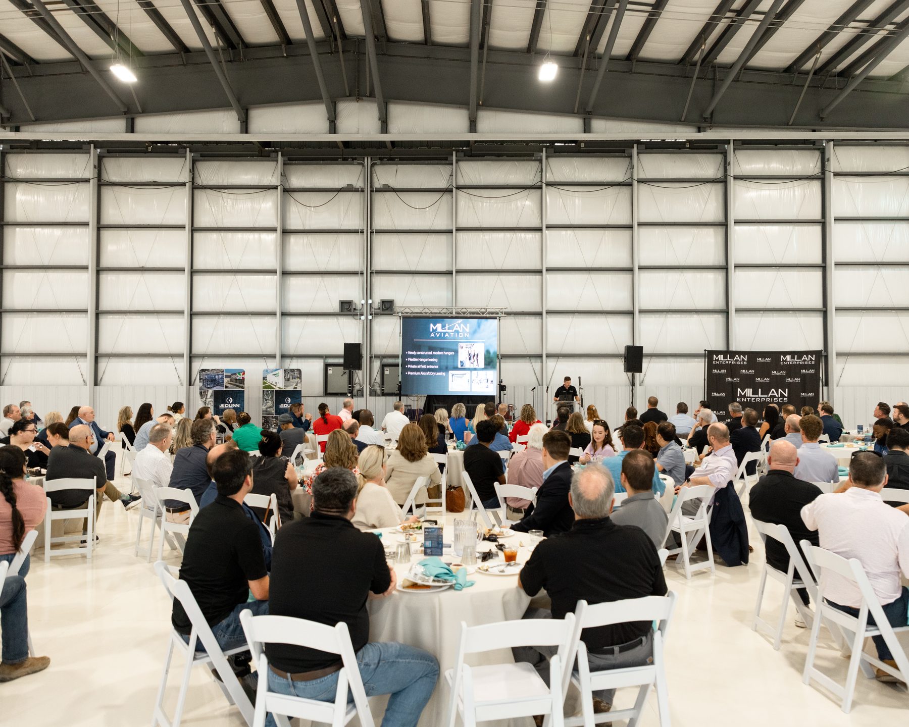 Corporate event room setup with dining tables